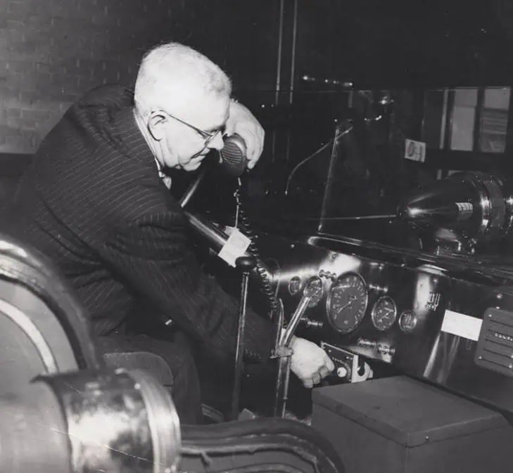 Historical photo of founder Jim Cattron installing a two-way radio for the Ellwood City Fire Department
