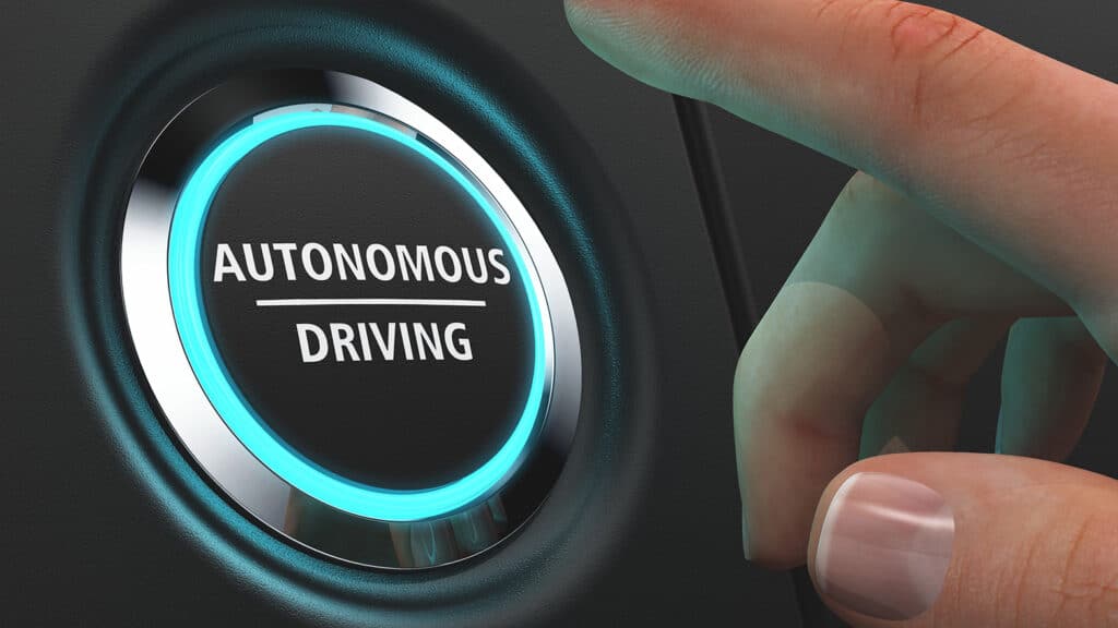 finger pushing a start button for an autonomous driving vehicle