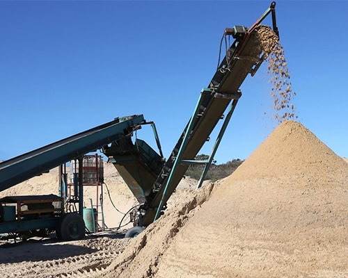 rock crusher mobile conveyor with a rock pile