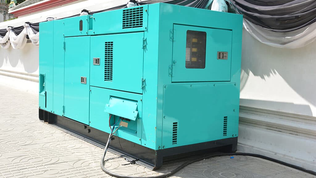 teal blue mobile generator siting outside next to a building
