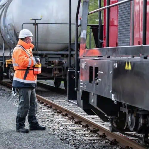 railyard worker next to locomotive