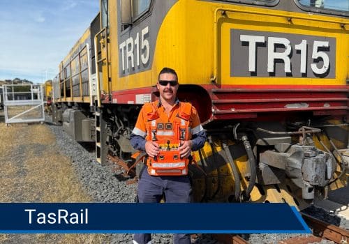 locomotive operator in front of train with cattron locomotive remote control