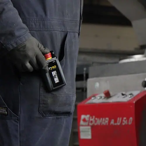 factory worker with tyro emergency stop hooked on pocket